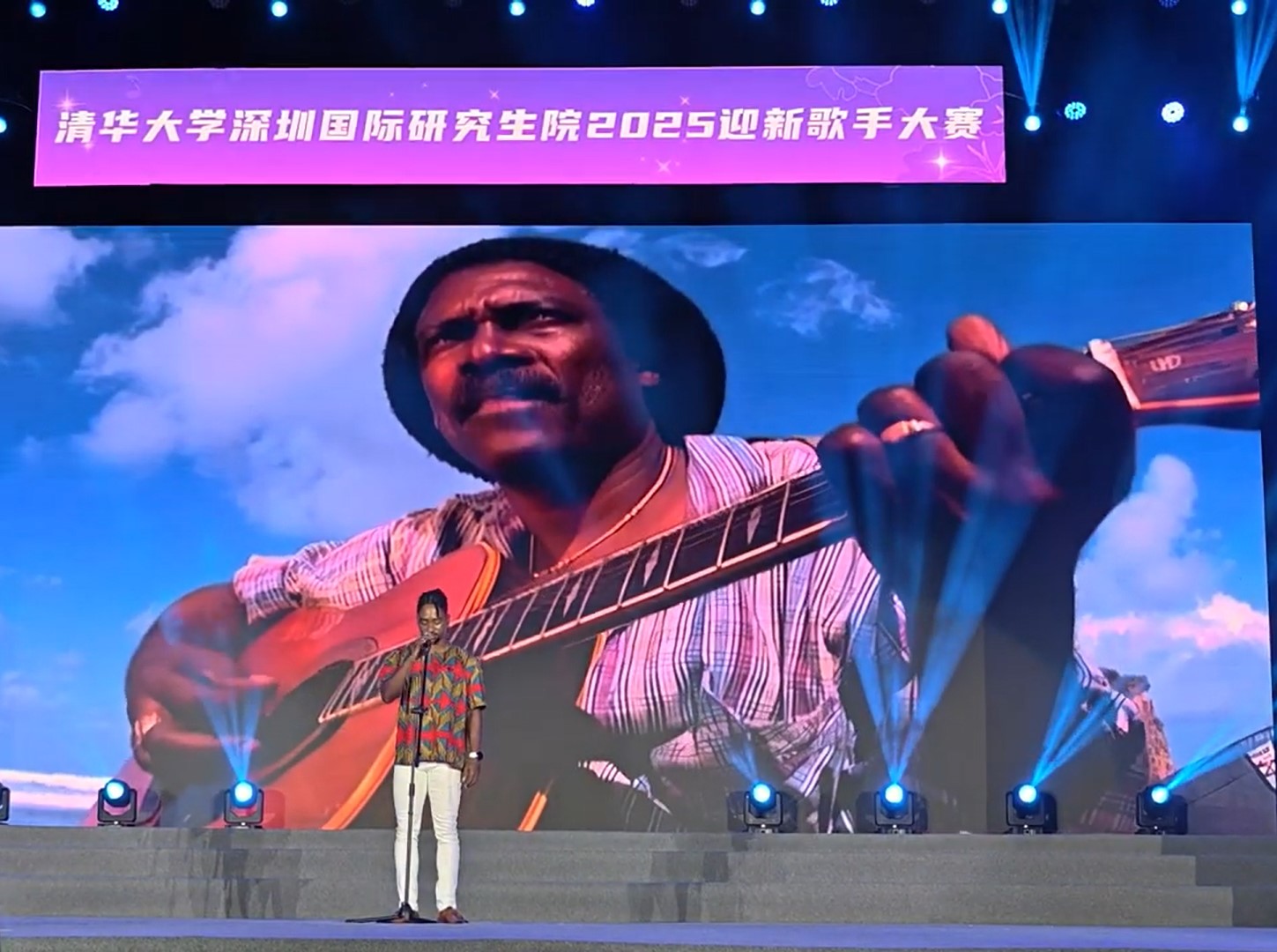 Joshua singing “Emmerton” against a background of a giant projection of Gabby on the guitar – Youtube